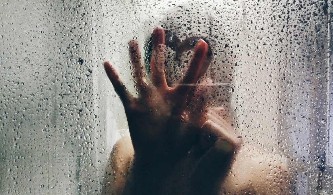 person touching clear shower glass