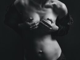 Grayscale Photography of Topless Woman Covering Her Boobs