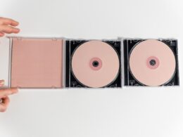 A Compact Discs on White Surface