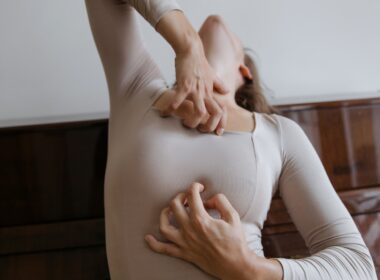 Woman in Beige Long Sleeves Scratching Her Chest