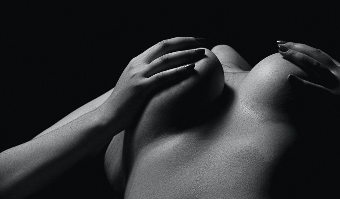 Grayscale Photo of Woman's Chest