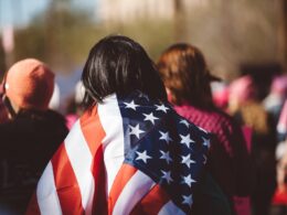 woman with US American flag on her shoulders