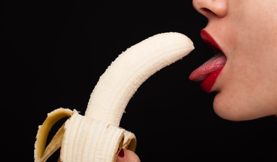 person holding banana with tongue out