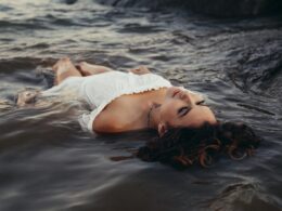 woman relaxing on body of water
