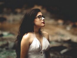shallow focus photography of woman in white halter top facing sideways