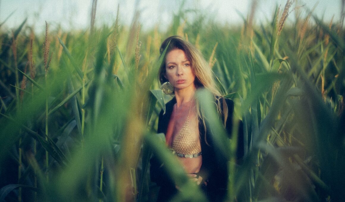 woman standing on corn field at daytime
