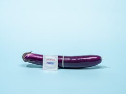 a purple eggplant with a sticker on it