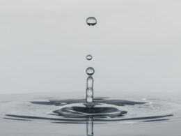 a drop of water falling into a body of water